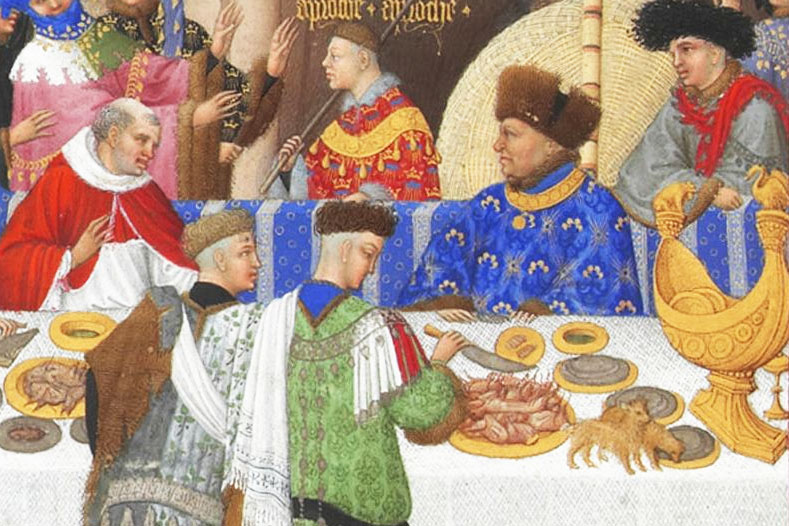 Depiction of Jean de Berry sat at the table wearing a blue garment